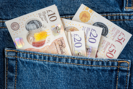 Jeans with British pound money. United Kindom bills in the pants pocket for commerce concept.の写真素材