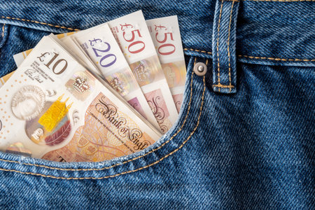 Jeans with British pound money. United Kindom bills in the pants pocket for commerce concept.の写真素材
