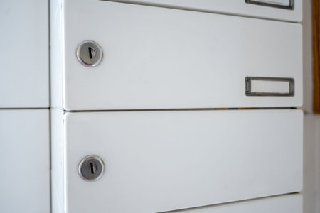 Postbox for letters in modern apartment house. The letter in metal white mailbox in lobby of...