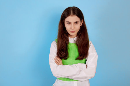 Young brunette teenage girl angry and upset on blue background.の写真素材