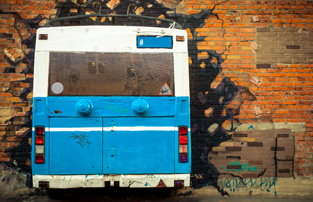 old blue and white bus painted on old brick wallの写真素材