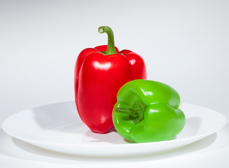 tasty delicious red and green peppers on the plateの写真素材