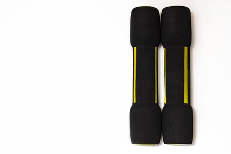 Two black dumbbells with a soft coating on a white background. Healthy lifestyle. Training. Workoutの写真素材