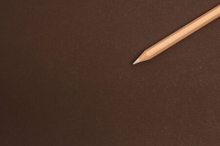White pencil lies diagonally on a black background. One pencil on black backgroundの写真素材