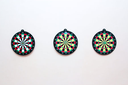 Dartboard with a dart on a gray wall close up. Darts game