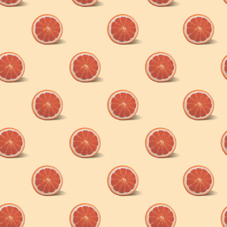 Seamless pattern with grapefruit on a pale light pink background.