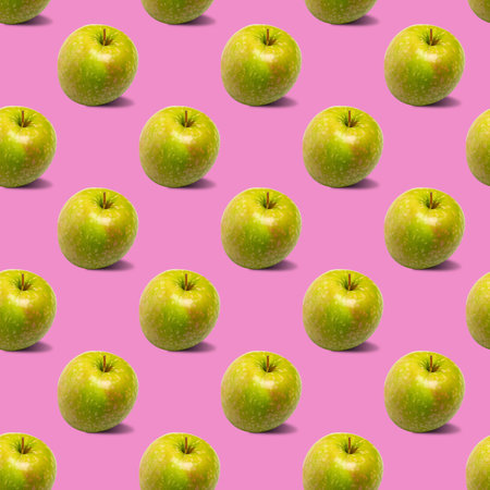 Seamless pattern with green apples on a pink background