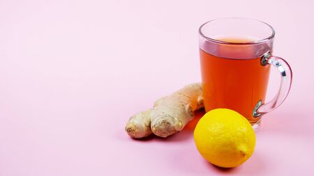 Ginger tea in a glass cup, next to it lemon.の写真素材