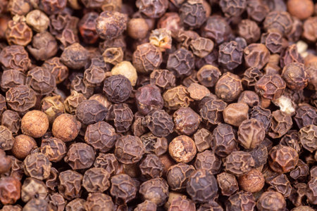 Top view black pepper spice texture. Macro photo. Spices and seasonings are good for your health.