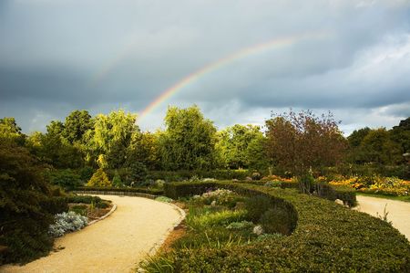 Park with a storming sky and two rainbowsの写真素材
