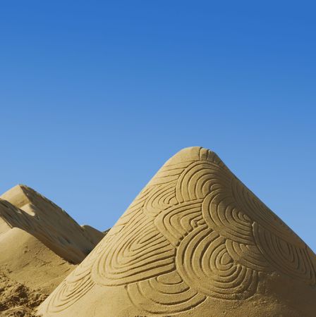 Sand sculpture on the beach with blue skyの写真素材