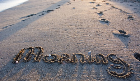Word "morning" written on the sand. Rose morning light の写真素材