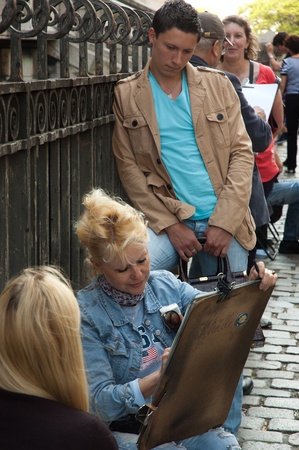 Paris, France, April, 23, 2011 - Artist painting people on Montmartre on April 23, 2011 in Paris, France. Montmartre is famous historical artistic centre of Parisのeditorial素材