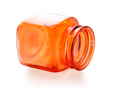 Empty orange square glass jar isolated on whiteの写真素材