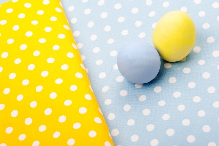 Blue and yellow Ester wooden eggs on napkinの写真素材
