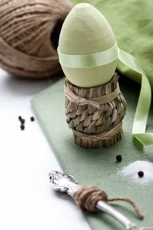 Table setting in green with egg and soltの写真素材