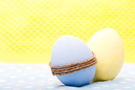Ester wooden eggs on blue and yellow napkins の写真素材
