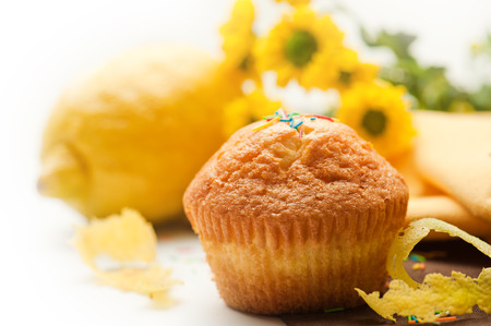 Muffin with lemon, zest and yellow flowersの写真素材