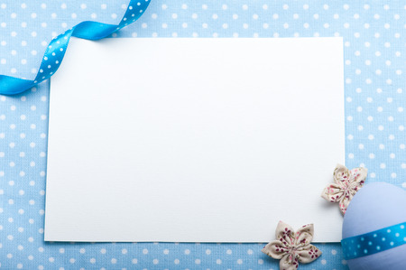 Blank card for newborn boy with blue egg and ribbonの写真素材
