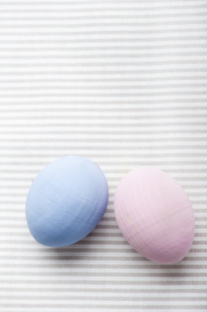 Blue and pink eggs on gray napkin の写真素材