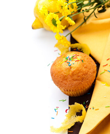 Muffin with lemon, zest and yellow flowersの写真素材