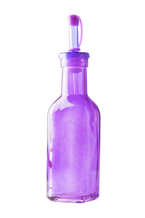 Empty purple glass bottle standing isolated on white の写真素材