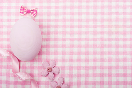 Pink egg and ribbon on napkin の写真素材