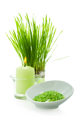 Green bath salt and candle SPA setting with green grassの写真素材