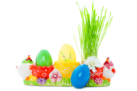 Vibrant easter eggs and green grass in a multicolor holderの写真素材