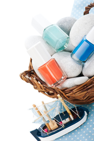 Bascket with stones, multicolor nail polish, toy boatの写真素材