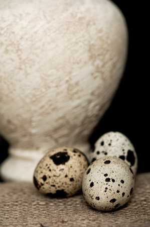 Still life with quail eggs and an antique vase. Narrow focusの写真素材