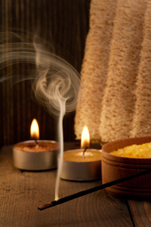 Spa setting and fuming aroma stick on dark wooden backgroundの写真素材