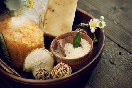 Still life with yellow and white bath salts on dark wooden background. Sepia tonedの写真素材