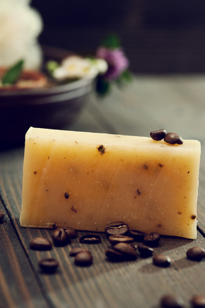 Handmade soap closeup with coffee beans and spa products on background. Toned imageの写真素材