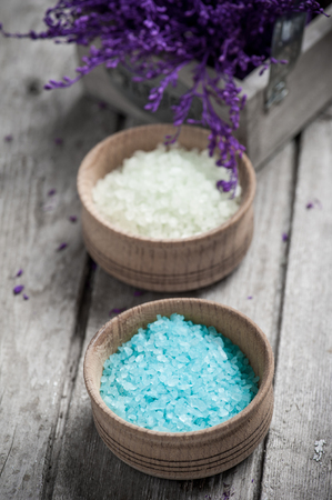 SPA still life, Bath Salt closeup with violet flowers on wooden background. Desaturatedの写真素材