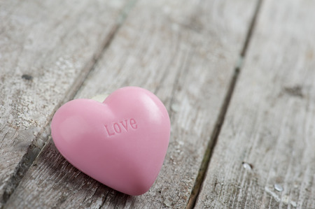 Pink Soap Heart on wood background. Sign Loveの写真素材