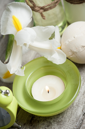 SPA still life, green lit candle, bath products, wooden backgroundの写真素材