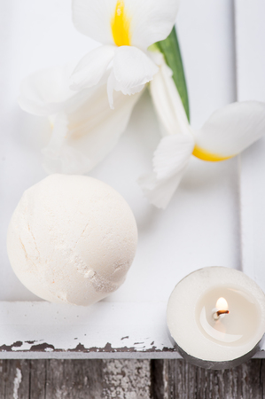 SPA still life, vanilla bath bomb closeup lit candles on wooden background. Shallow depth of fieldの写真素材