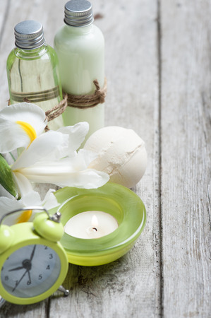 SPA still life, green lit candle, bath products, wooden backgroundの写真素材