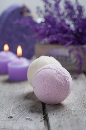 SPA still life,bath bombs closeup with violet flowers on wooden background.の写真素材