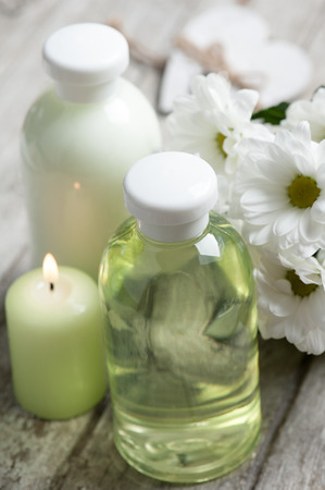 SPA still life, bath products, lit candle, wooden background, greenの写真素材