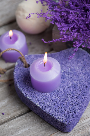 SPA still life, Purple pumice closeup with violet flowers on wooden background.の写真素材