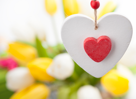 White and red wooden heart and tulips on backgroundの写真素材