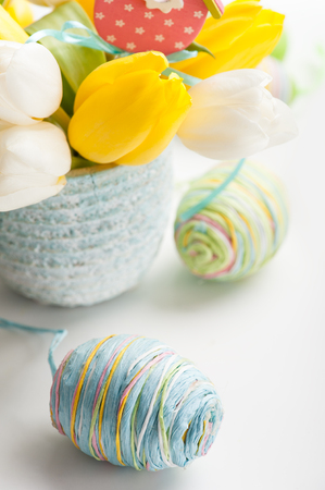 Paper egg closeup. Easter decoration. Tulips and easter eggs on backgroundの写真素材