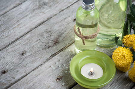 SPA still life, green lit candle, bath products, wooden backgroundの写真素材