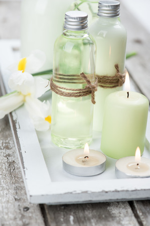 SPA still life, bath products, lit candles, wooden background, greenの写真素材