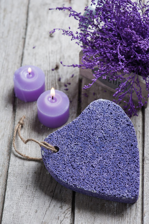 SPA still life, Purple pumice closeup with violet flowers on wooden background.の写真素材