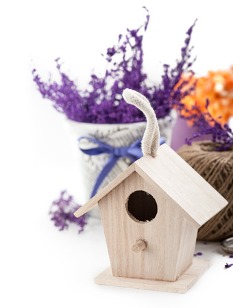 Bird house and purple branches in the pot. Gardening decorationの写真素材