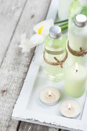 SPA still life, bath products, lit candles, wooden background, greenの写真素材