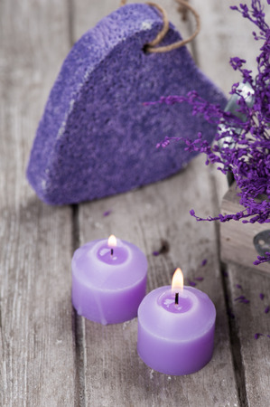 SPA still life, Purple pumice closeup with violet flowers on wooden background.の写真素材